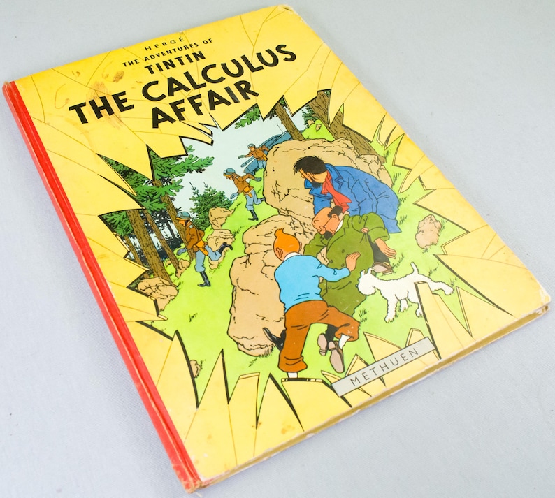 May include: A vintage copy of "The Calculus Affair" by Herg&eacute;, featuring a yellow cover with a comic illustration. The cover has the title in bold black letters and a red spine. The illustration depicts characters in a mountainous setting.