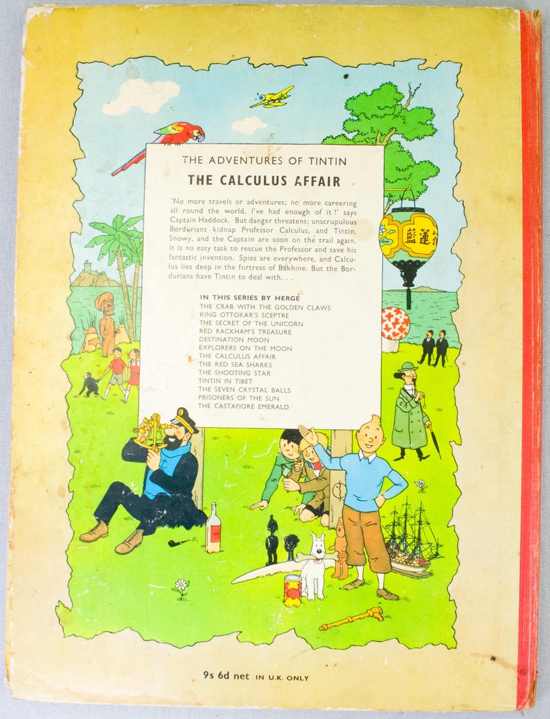 May include: The back cover of "The Adventures of Tintin: The Calculus Affair" comic book. The cover features colorful illustrations of Tintin, Captain Haddock, and other characters. The book's title and series are displayed at the top.