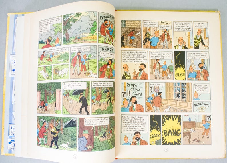 May include: Open book with colorful comic strip panels. The illustrations feature characters in various scenes with speech bubbles. Text includes "WOODOV", "BARROW", "GLING BLING CLING", and sound effects like "CRACK" and "BANG".