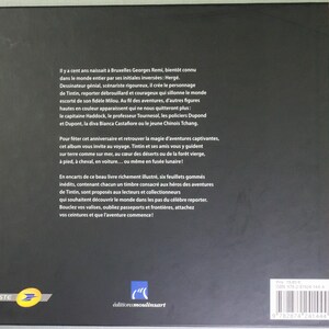 May include: A book cover with a black background and white text in French. The book has a red spine and a barcode. The text describes the adventures of Tintin, a comic book character. The book is published by &Eacute;ditions Moulinsart.