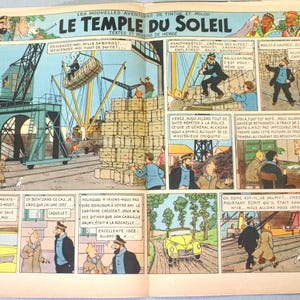 May include: A vintage comic book page from The Adventures of Tintin titled Le Temple du Soleil by Herg&eacute;. The colourful illustration features multiple panels depicting a harbour scene with cranes, cargo crates, a yellow car, and characters Tintin and Captain Haddock in various settings with French dialogue bubbles.