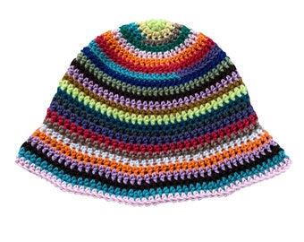 May include: A multi-coloured crochet bucket hat. The hat is made with a variety of yarns in shades of red, orange, blue, green, and purple, creating a striped pattern. The brim is finished with a light pink edge. A unique, handmade accessory.
