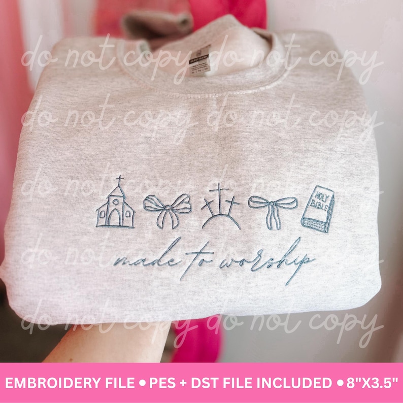 May include: Light gray sweatshirt with embroidered religious symbols, including a church, bows, crosses, and a Bible. The phrase "made to worship" is embroidered below the symbols. The sweatshirt measures 8" x 3.5".