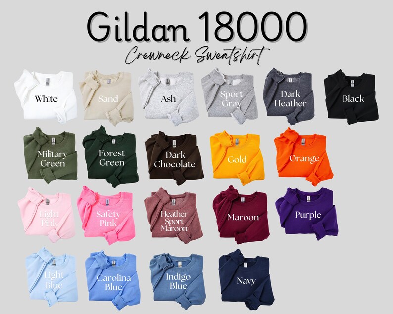 May include: A Gildan 18000 crewneck sweatshirt color chart featuring nineteen folded long-sleeve shirts in various colors including white, sand, ash, sport gray, dark heather, black, military green, forest green, dark chocolate, gold, orange, light pink, safety pink, heather sport maroon, maroon, purple, light blue, carolina blue, indigo blue, and navy.