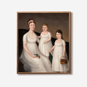 May include: A framed portrait of a woman and two children. The woman is seated, wearing a white dress and holding flowers. The children, also in white dresses, stand beside her. One child holds a basket of flowers. The portrait has a gold frame.