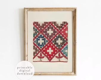 May include: A framed wall art print featuring a quilt pattern with a grid of diamond shapes in red, blue, brown, and white. The design includes floral and geometric motifs with small white rectangular labels in the center of each diamond. A circular white badge in the corner displays the text printable digital download.