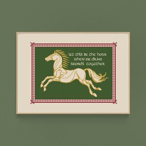 May include: A framed cross-stitch design featuring a white horse with a gold outline, galloping to the right. The background is green with a red and gold border. The text reads "Let this be the hour when we draw swords together."