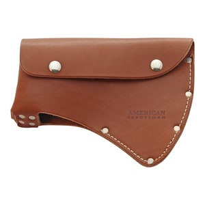 May include: A brown leather axe sheath with a flap secured by two silver snaps. The sheath is stitched with white thread and has the words "AMERICAN TRADESMAN" embossed on the front.