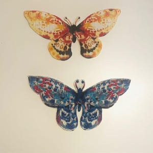 May include: A set of three ceramic mugs with a speckled, matte finish. The mugs are in shades of cream, light gray, and dark gray. Each mug has a simple, minimalist design and a rounded handle.