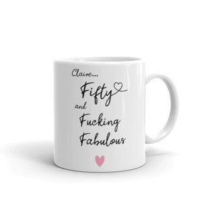 May include: White ceramic mug with black text that reads "Claire... Fifty and Fucking Fabulous" with a pink heart at the bottom.