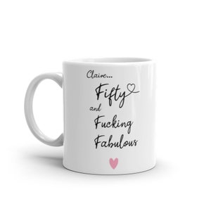 May include: White ceramic mug with black text that reads "Claire... Fifty and Fucking Fabulous" with a pink heart at the bottom.