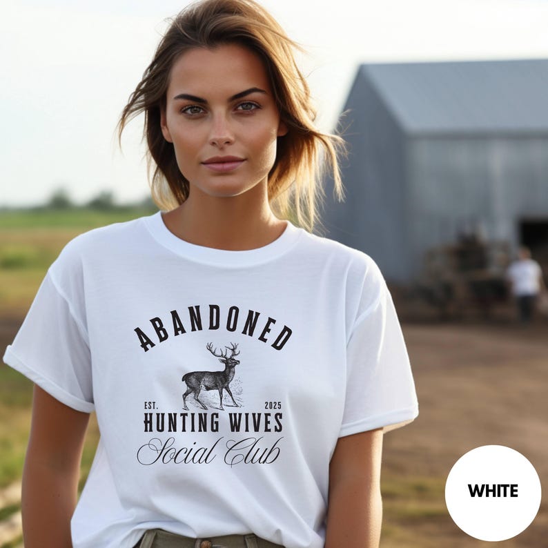 A sweatshirt and shirt featuring the Abandoned Hunting Wives Social Club design with a vintage deer illustration and bold rustic lettering, perfect for hunting wives, fall season wear, hunting camp gatherings, and cozy casual outfits.