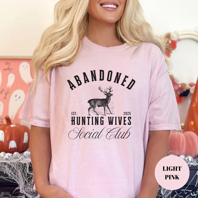 A sweatshirt and shirt featuring the Abandoned Hunting Wives Social Club design with a vintage deer illustration and bold rustic lettering, perfect for hunting wives, fall season wear, hunting camp gatherings, and cozy casual outfits.