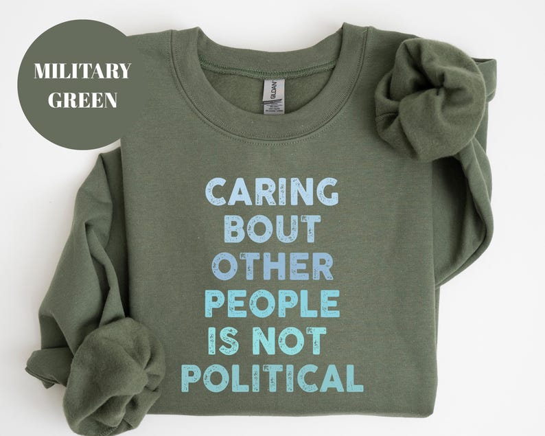 Bold statement sweatshirt with the phrase Caring About Other People Is Not Political, promoting kindness, activism, and human rights.