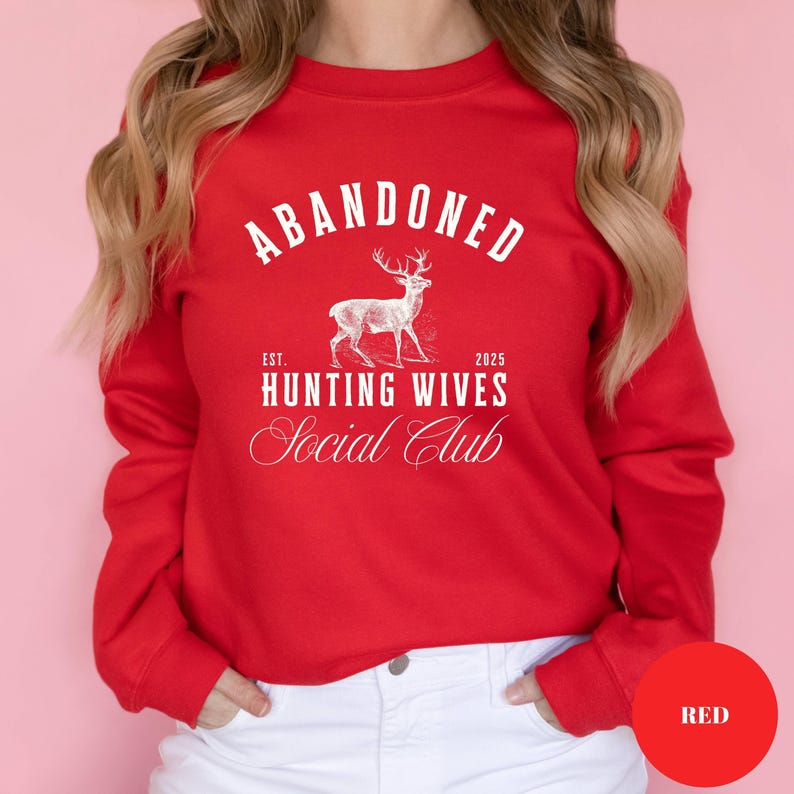 A sweatshirt and shirt featuring the Abandoned Hunting Wives Social Club design with a vintage deer illustration and bold rustic lettering, perfect for hunting wives, fall season wear, hunting camp gatherings, and cozy casual outfits.