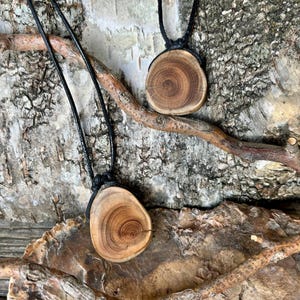 Yew wood protective amulet, pendant on a leather cord