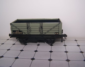 May include: A green toy train car with black wheels and the text "12T E 404844 6-8" printed on the side.