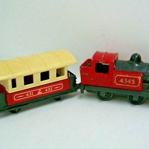 Könnte beinhalten: Ein rotes und schwarzes Spielzeug-Zugsatz mit einem Personenwagen und einer Lokomotive. Der Personenwagen hat ein cremefarbenes Dach und Fenster. Die Lokomotive hat einen schwarzen Kessel und eine rote Kabine. Die Lokomotive hat die Nummer 4345 an der Seite. Der Personenwagen hat die Nummern 431 und 432 an der Seite.