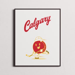 Puede incluir: Una impresión enmarcada en blanco con la palabra "Calgary" en texto rojo y un disco de hockey rojo de dibujos animados con una cara sonriente que lleva un sombrero blanco y sostiene un palo de hockey.