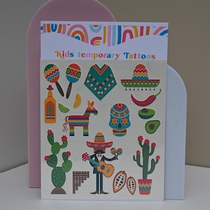 May include: A sheet of temporary tattoos with a colorful Mexican theme. The tattoos feature images of a maraca, a sombrero, a cactus, a skull, a donkey, and a man playing a guitar. The sheet is labeled "Kids temporary Tattoos".