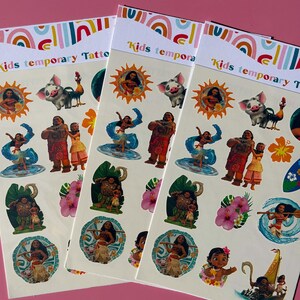 May include: Three packs of kids temporary tattoos featuring characters from a popular animated movie. Each pack has a white background with colorful illustrations of characters, flowers, and a boat. The text "Kids temporary Tattoos" is printed at the top of each pack.