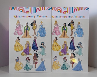 May include: Two sheets of temporary tattoos featuring Disney princesses. The sheets are white with a rainbow design at the top and the words "Kids temporary tattoos" printed in black. The sheets feature 12 different princesses, including Cinderella, Snow White, Ariel, Belle, and Pocahontas.