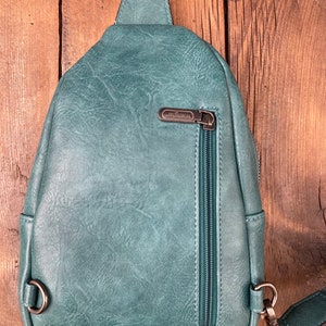 Crossbody Bag with Hand Tooled Patch and Fringes. 5399