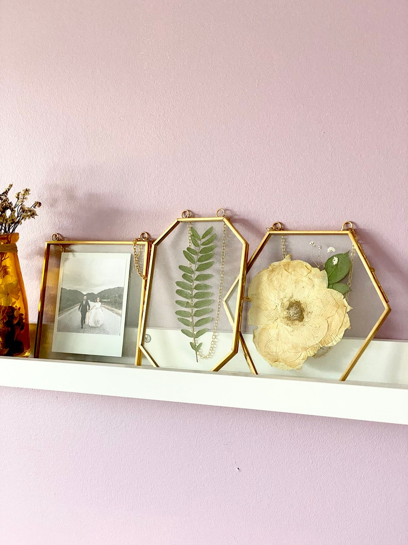 A set of 3 gold picture frames containing a 5x5 square, 4x6 octagon and a large hexagon. Elegant yet minimalistic decor for your home. Perfect for creating little thoughtful gifts for your loved ones.