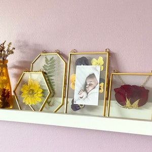 A set of 4 gold picture frames containing a 4x4 square, 4x6 octagon, 4x6 rectangle and a small hexagon. Elegant yet minimalistic decor for your home. Perfect for creating little thoughtful gifts for your loved ones.