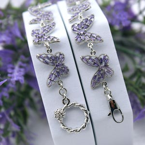 Platinum Plated Butterfly Bracelet with Light Purple Rhinestone. Toggle or Lobster Clasp. Flower Charm.