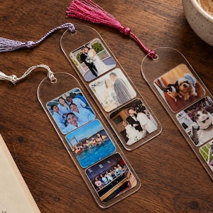 May include: Three clear acrylic bookmarks with rounded tops, each featuring a vertical series of square photo prints. The bookmarks are adorned with shimmering tassels in lavender, silver, and hot pink, displaying various personal images of people and pets.