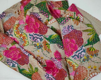 May include: A beige kantha quilt with a floral pattern in shades of pink, green, orange, and brown. The quilt is hand-stitched and has a vintage look.