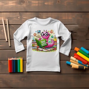 May include: White long-sleeve shirt with a pink worm wearing glasses and reading a book that says "100 Days Smarter". The worm is surrounded by colorful books, pencils, and other school supplies.