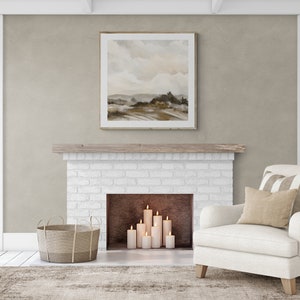 May include: A white brick fireplace with a wooden mantel and a framed landscape painting above it. The fireplace has a black hearth and is decorated with lit candles.