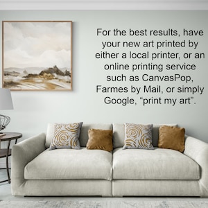 May include: A white couch with three throw pillows, one with a gold swirl pattern, one with a solid gold color, and one with a brown swirl pattern. The couch is in front of a white wall with a framed painting of a landscape scene and text that reads: "For the best results, have your new art printed by either a local printer, or an online printing service such as Canvas Pop, Frames by Mail, or simply Google, "print my art"."
