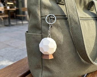 Meridia's Beacon Keychain with Stand - A New Hand Touches The Beacon