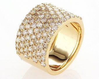 May include: A gold band ring with a wide, flat top set with a row of small, round diamonds.