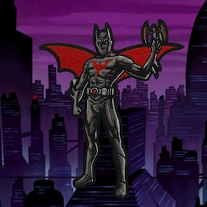 May include: A black and red embroidered patch of Batman Beyond, a superhero with a red cape and bat-like wings, standing in a city skyline.