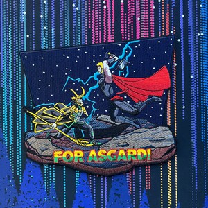 May include: Embroidered patch featuring Thor and Loki from the Marvel comics. Thor is wielding his hammer, Mjolnir, and Loki is holding a staff. The patch is set against a starry night sky and features the text "FOR ASGARD!" in yellow.