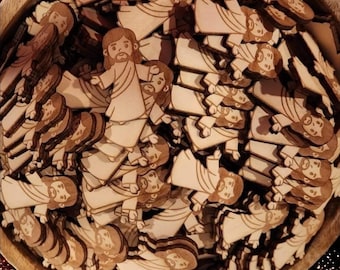 May include: A bowl filled with wooden cutouts of Jesus in various poses. The cutouts are all the same size and shape, and they are made of light brown wood.