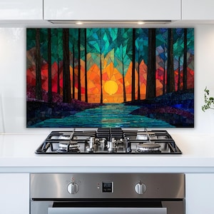 May include: A colorful mosaic art piece depicting a forest scene with a sunset. The artwork features tall trees in shades of green and red, a bright orange sun, and a blue river. The art is mounted above a stove.