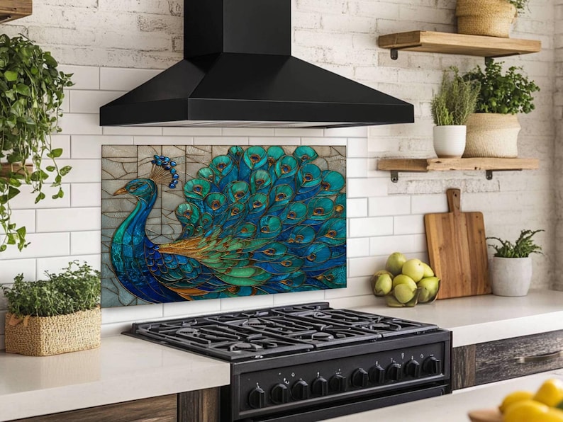 Vibrant peacock stained glass kitchen backsplash with shades of blue and teal. The artistic panel is mounted behind a professional black gas range in a kitchen with large-format beige marble wall tiles and a stainless steel range hood.