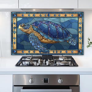 May include: A blue and gold stained glass panel featuring a sea turtle. The turtle has a blue shell with purple accents and a gold head and flippers. The panel is framed with a gold and blue geometric border.