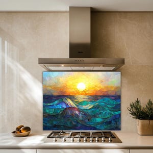 A stained-glass style backsplash featuring an ocean sunset with rolling waves is set in a modern kitchen with beige stone walls. It sits behind a gas cooktop, flanked by a fruit bowl and a potted plant.