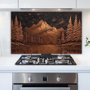 May include: A copper-toned landscape art piece featuring a mountain range, evergreen trees, and a starry night sky. The artwork is mounted above a stovetop, adding a decorative element to the kitchen.