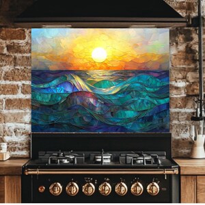 A stained-glass style backsplash featuring an ocean sunset with rolling waves is set against an exposed brick wall. It sits above a black vintage-style range with gold knobs, flanked by wooden kitchen accessories.