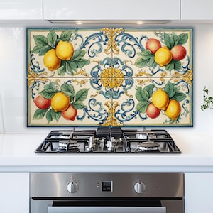 May include: Decorative tile backsplash featuring a vibrant design of lemons and peaches with green leaves, set against a cream background with blue and gold scrollwork. The tiles are arranged above a gas stovetop.
