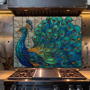 Vibrant peacock stained glass kitchen backsplash with shades of blue and teal. The artistic panel is mounted behind a professional gas range in an industrial kitchen with dark concrete-textured walls and warm under-cabinet lighting.