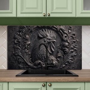 May include: A black, rectangular kitchen backsplash featuring a detailed relief of a rooster within a decorative frame. The rooster is centered, with intricate feather and facial details. The backsplash is set above a black sink and a wooden countertop.