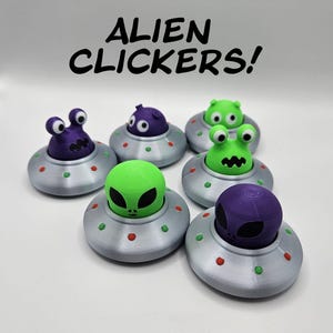 May include: Six alien clicker toys, each with a different expression. The aliens are green and purple and are riding in silver flying saucers with red and green dots.
